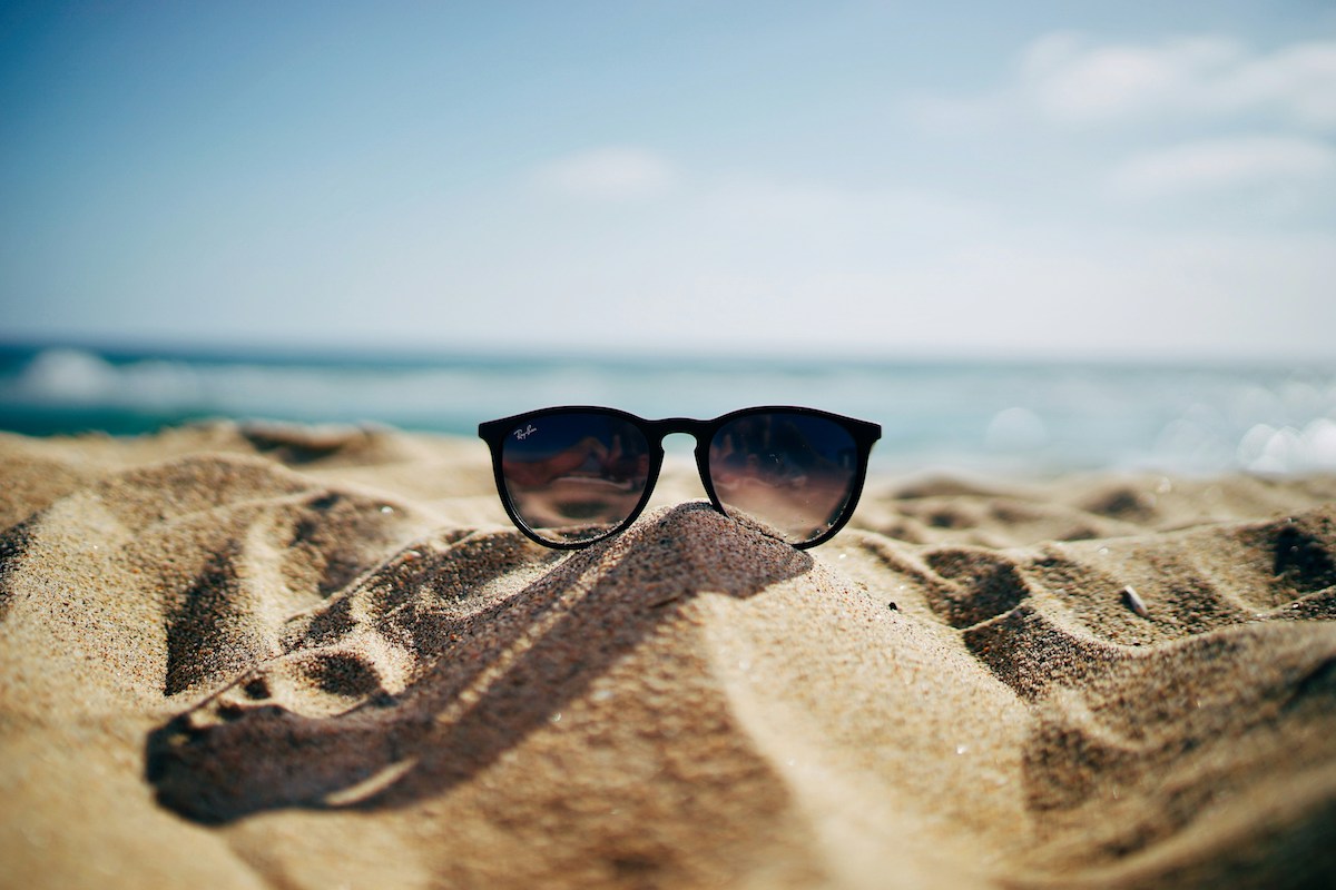 Plan your sunglasses in the sand with one way trip platinum travel insurance 