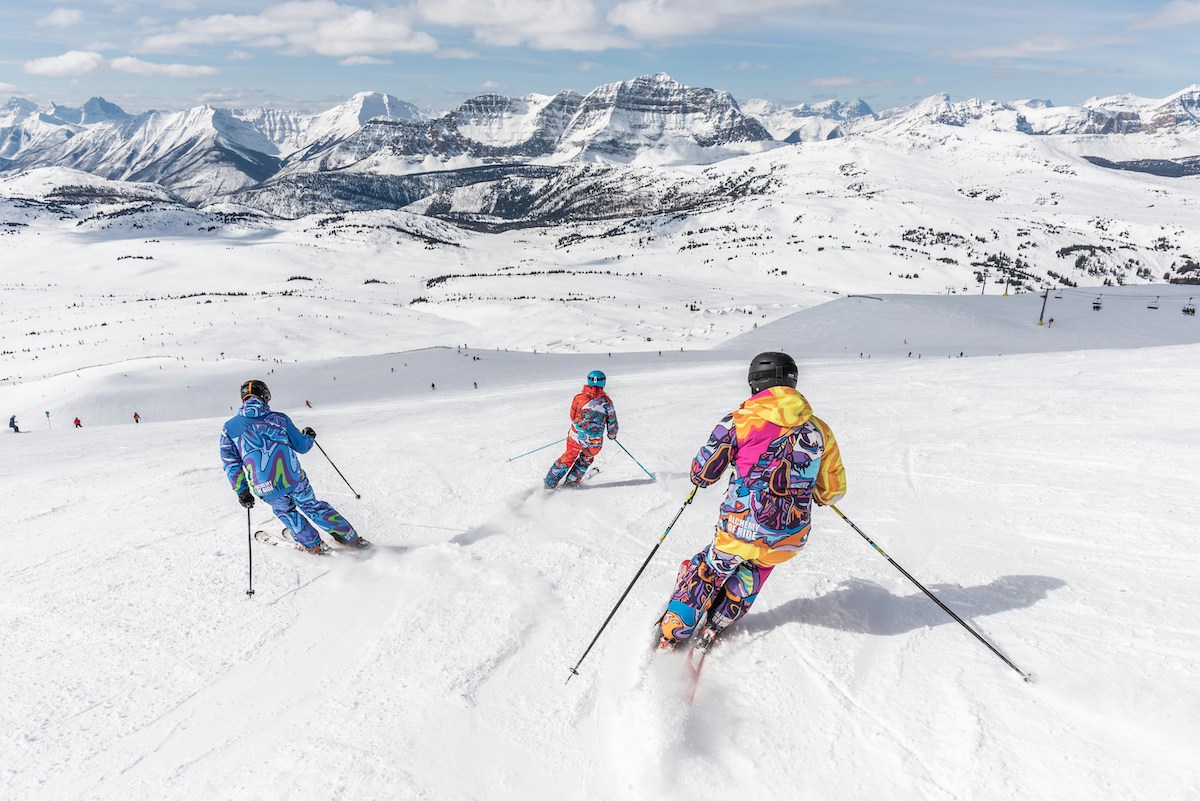 A group of skiers going down Banff Sunshine slopes