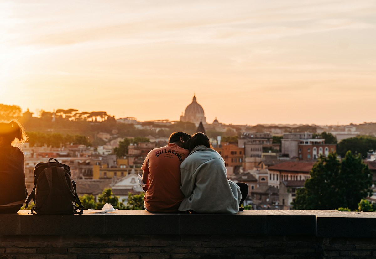 Couple enjoying the view from the Giardino degli Aranci in Rome, Italy during golden hour